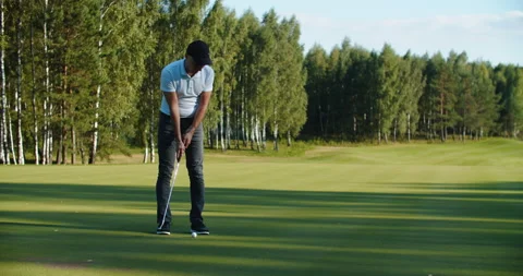 A man golfer in a cap plays on the field. Time for golf Stock Footage 220659224