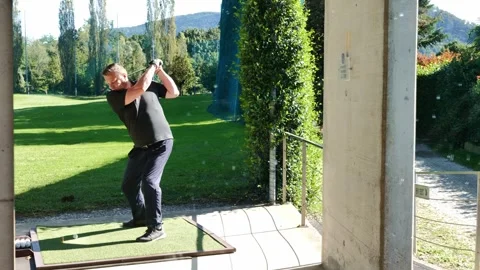 Man Golfer Training His Golf Swing in Driving Range in a Sunny Summer Day Stock Footage 264576398