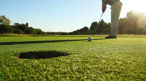 Man Golfing And Putting Ball In Hole Stock Footage