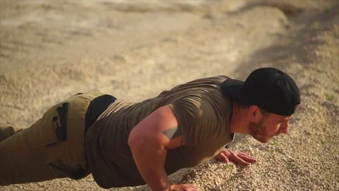 A man in good physical shape is squeezed off the floor in nature on a summer day Stock Footage