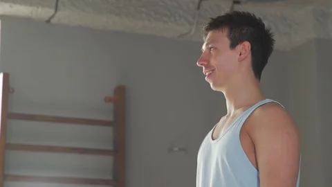 A man with a good stretch makes a deep inclination to the toes Stock-Footage 76187846