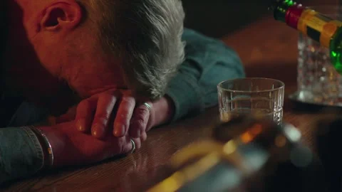 Man got drunk with alcohol and sleeps on the bar counter. Drunken elderly Stock Footage 253629104