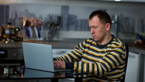 A man got a phone call while he was working on a laptop. Stock Footage 132296139