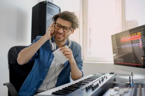 The man got sick. He has a headache Composer in the recording studio. music Stock Photos