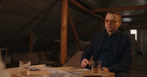 The man gots bad card combination . He takes his gun and targeting other person  Stock Footage 117672430