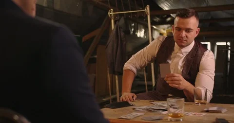 The man gots bad card combination . He takes his gun and targeting other person  Stock Footage 117672701