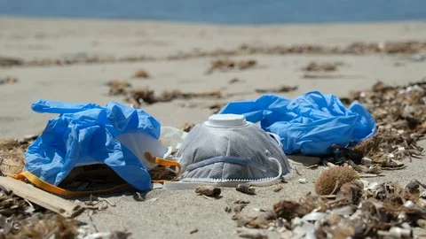 Man grab protective mask and plastic gloves on sea coast,coronavirus pollution Stock Footage 129849546