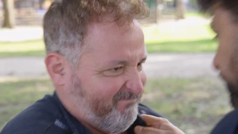 A man is grabbed ahold of by another man and is shaken and intimidated  - shot Stock Footage 124910807