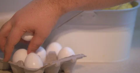 Man Grabbing Eggs out of a Half Dozen Carton Stock Footage 101052620