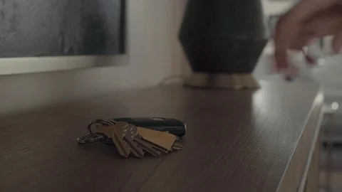 Man grabbing keys off table, hd Stock Footage