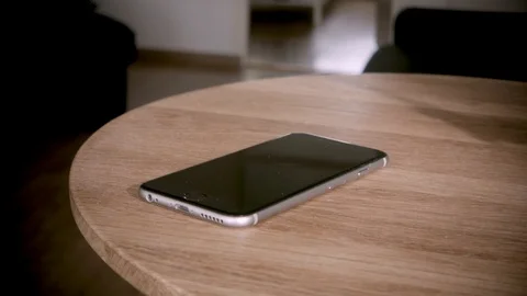 Man Grabbing Phone From A Table Vídeo Stock 127036091