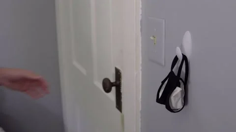 Man grabs Face Mask off Hook Stock Footage 138773215