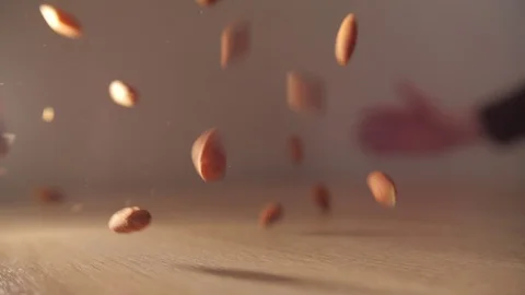 A man grabs a falling almond on the fly Video stock 129266093