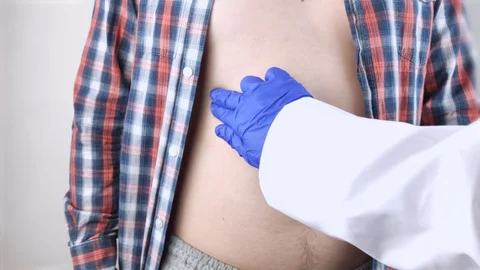 A man grabs his right side under the ribs. Pain in the liver. Pain syndrome in l Stock Footage 130112590