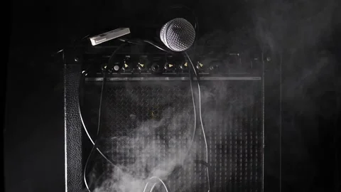 Man grabs Mic on top of guitar amp wire and cassette tape fall slow motion  Stock Footage 204960336