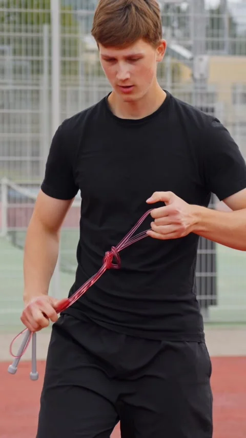 Man Grabs Wireless Earbuds Case and Prepares for Run During Outdoor Fitness Video stock 321865510