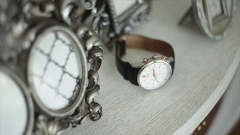 A man grabs wrist watch with backgrounds Stock Footage 80925886