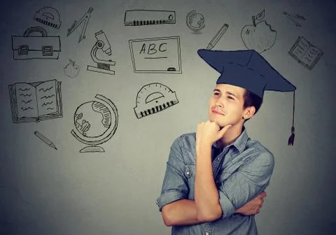 Man with graduation hat looking up thinking Stock Photos