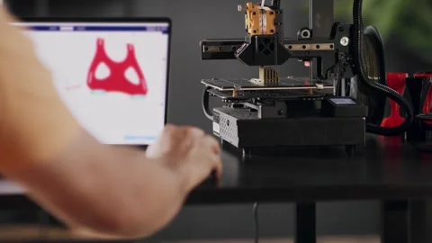 A man graphic designer develops a model of postoperative fixation bandage in Stock Footage 274490754