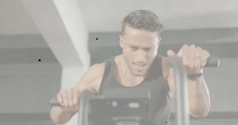 Man grasping handles and starting cardio in gym, fitness data tracking motion Stock Footage 334108935