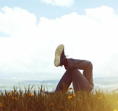 Man on the grass in sunset Stock Photos