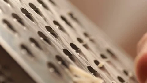 Man is grating cheese on a cutting board. Closeup of cook grating cheese Stock Footage 73274700