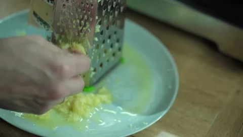 Man grating ginger, grater with ginger for healthy tea lemonade. 스톡 동영상 304787570