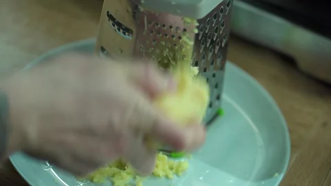 Man grating ginger, grater with ginger for healthy tea lemonade. Stock Footage 304788035
