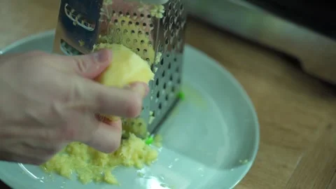 Man grating ginger, grater with ginger for healthy tea lemonade. Stock Footage 304788036