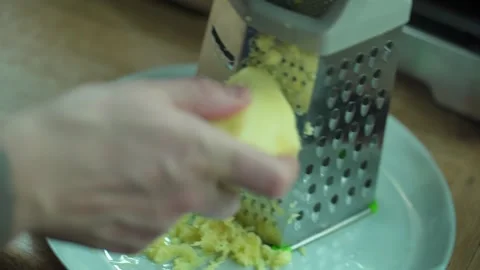 Man grating ginger, grater with ginger for healthy tea lemonade. Stock Footage 304788043