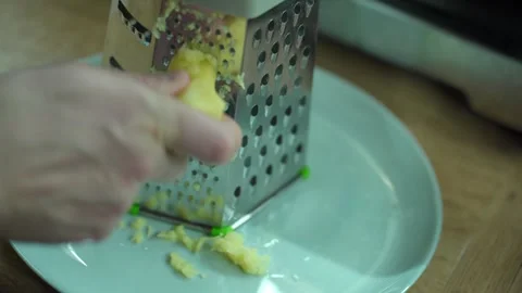 Man grating ginger, grater with ginger for healthy tea lemonade. Stock Footage 304788529