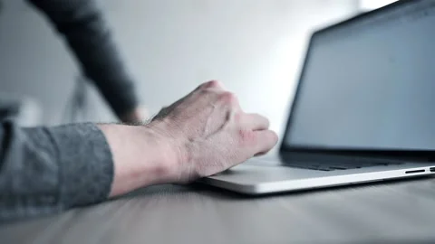Man in gray pullover surfs the internet with his laptop and uses touch pad Stock Footage 88834148