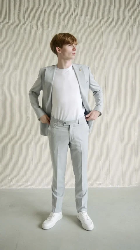 Man in gray suit standing in front of white wall Stock-Footage 274163901