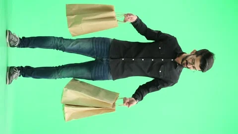 Man, on a green background, full-length, with bags Stock Footage 261404116