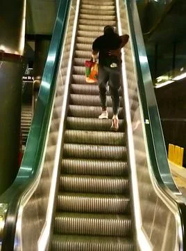 Man on the green escalator Stock Photos