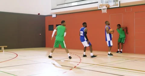 Man in green jersey #6 receiving pass in gym, dribbling, dunking to score, and Stock Footage 336057920