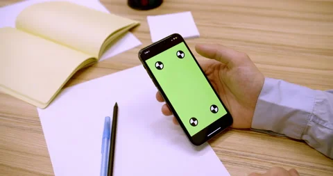 Man with green screen chroma key smartphone in office Stock Footage 170634962