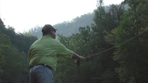 Man In a Green Shirt Casting His Line Stock Footage 24704749