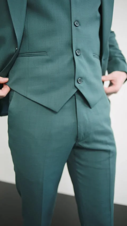 Man in green suit with hands in pockets Video stock 274163372