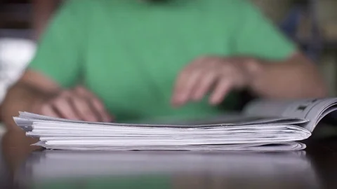 Man in the green t-shirt reading the newspaper closeup Stock Footage
