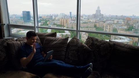 Man Greets using tablet for a video call Stock Footage 103199716