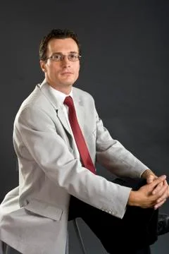 Man in grey jacket with red tie and glasses Stock Photos