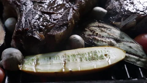 Man grilling and flipping steak and vegetables on the grill close-up Stock Footage 280471074