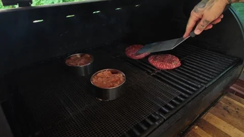 Man Grilling Beef and Low-Fat Turkey Burgers Side by Side Today Stock Footage 343845455