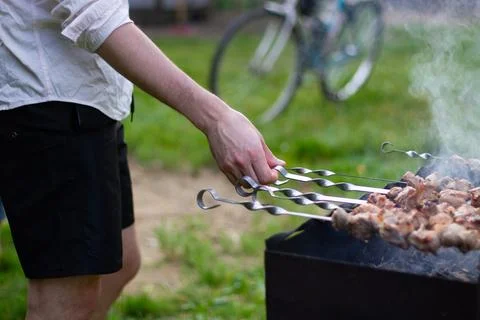 Man Grilling Kebabs In The Backyard Stock Photos