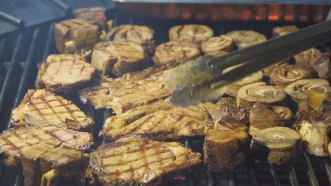A man is grilling meat. Video stock 122646554