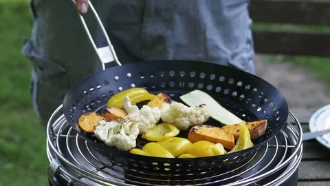 Man grilling mixed vegetables on a table grill Video stock 77161481