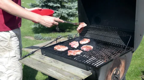 Man grilling outdoors Stockbeeldmateriaal 25291713