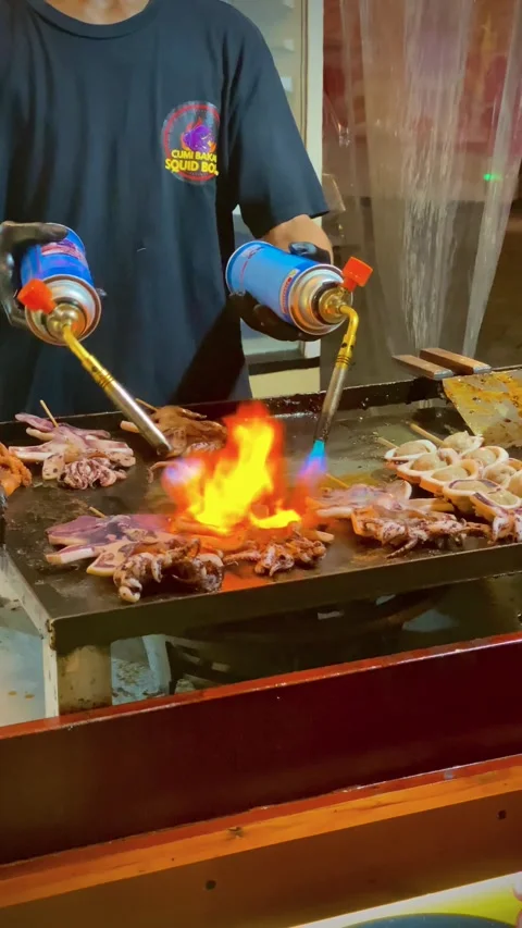Man grilling squids at barbecue using gas-burner Stock Footage 274932711