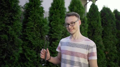 Man grilling vegetable on grill during family summer garden party, close-up Stock Footage 246661373